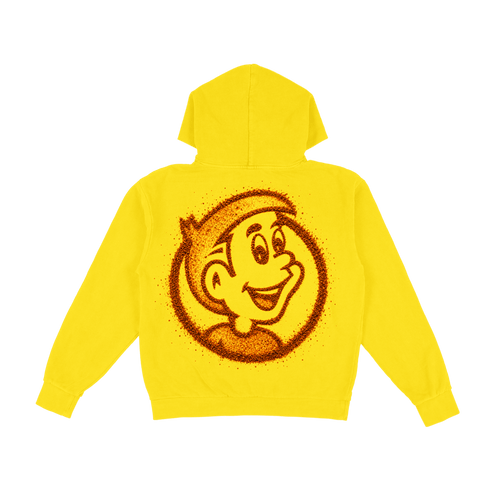 A bright yellow hoodie shown from the back, featuring a large circular graphic of a smiling cartoon face made from red tajin powder.